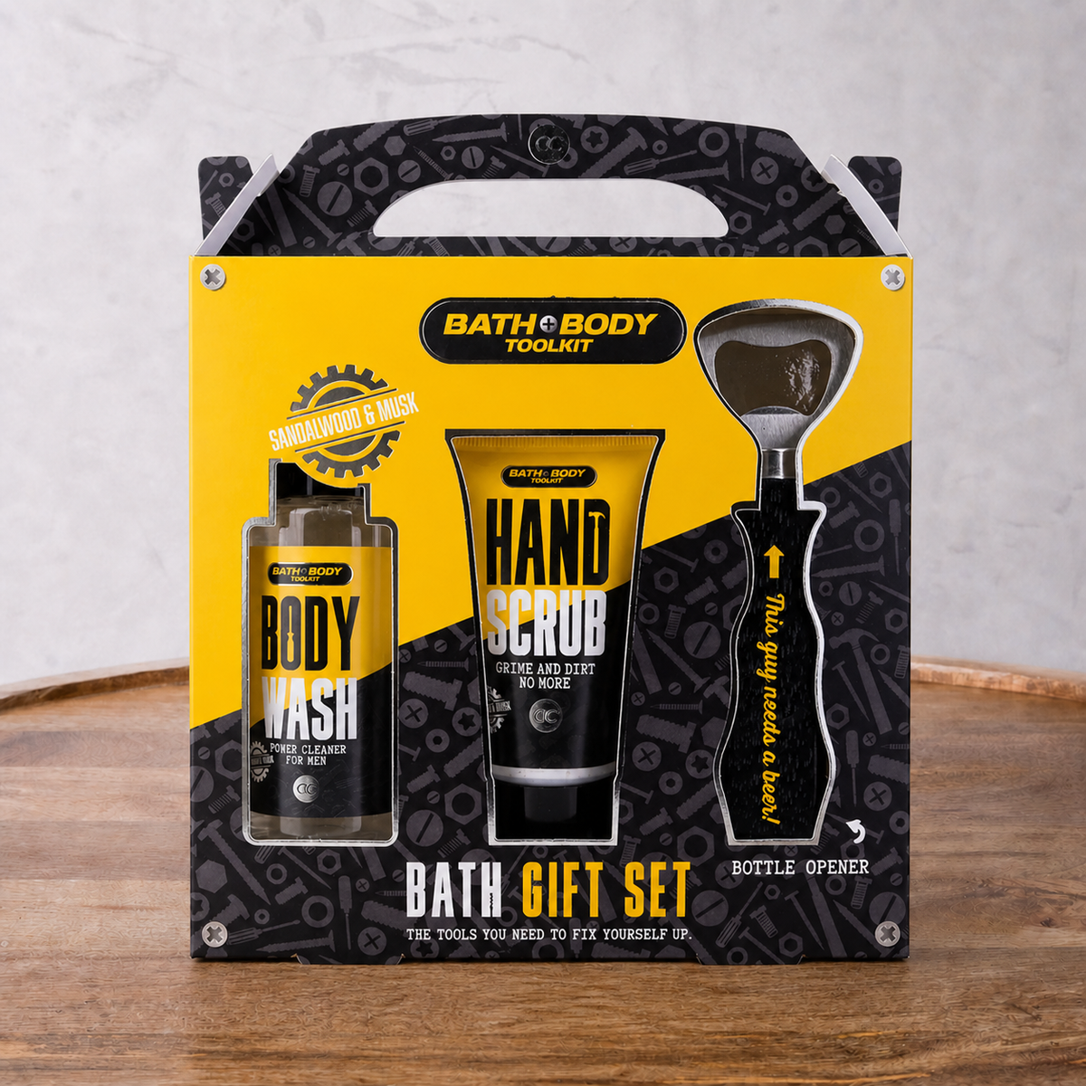Bath and Body Toolkit gift set with body wash, hand scrub, and bottle opener on a wooden surface.