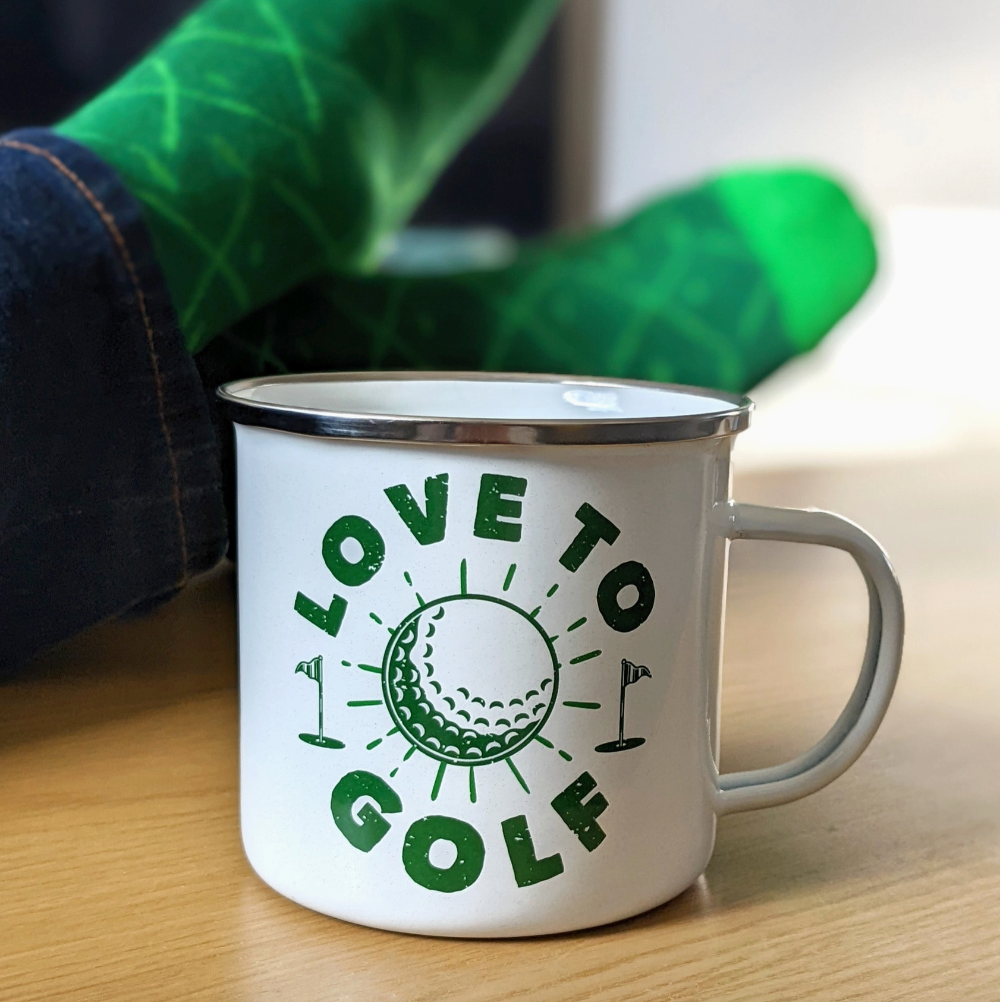 White mug with 'Love to Golf' design on a wooden surface